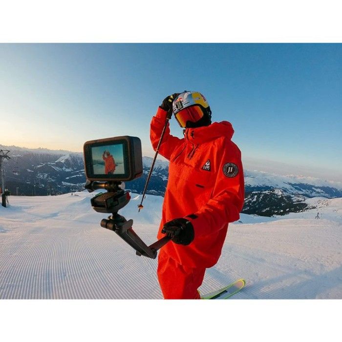 skiing person holding GoPro Hero 10 on snowy mountain